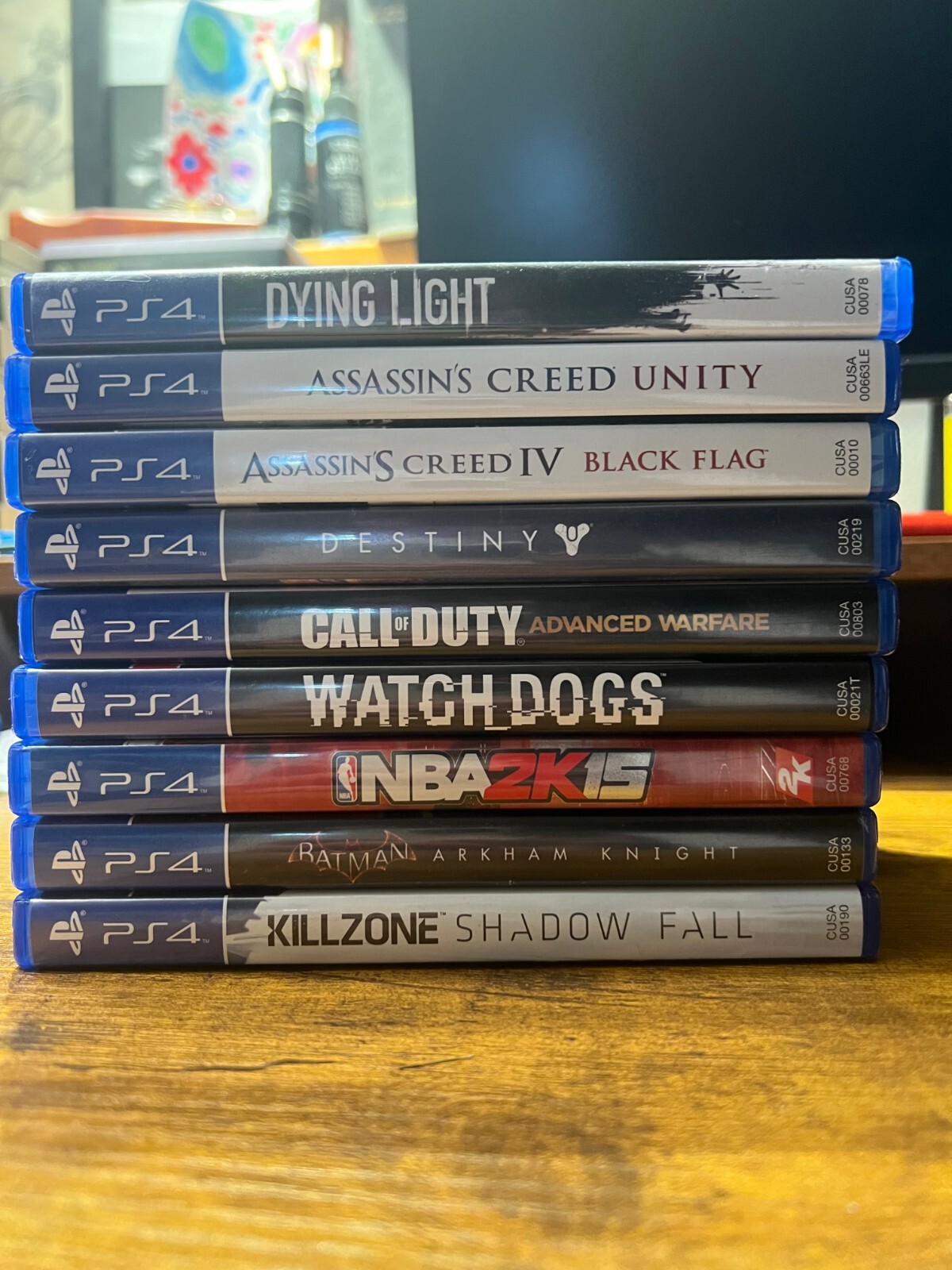 PlayStation 4 (Used) with 3 Controllers (red, white, and blue) and 9 PS4 Games