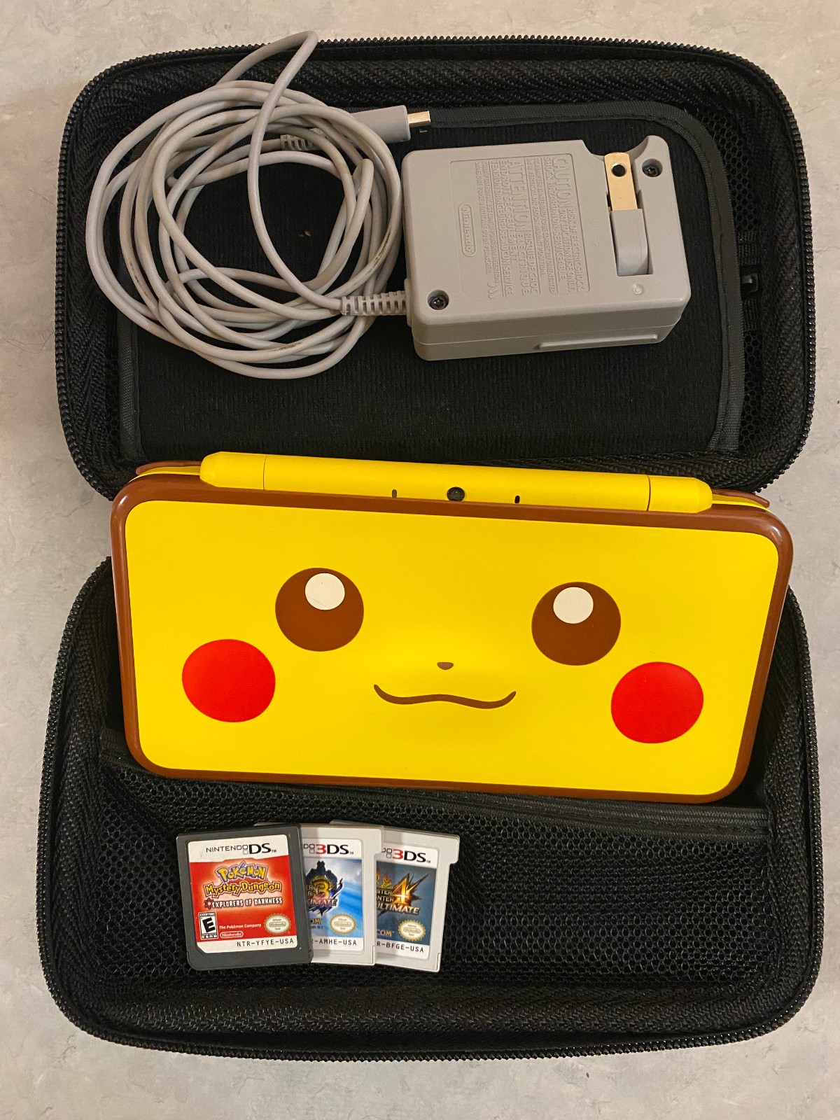 Nintendo 2DS XL Pikachu Edition w/3 Games, Charger, and Carrying Case