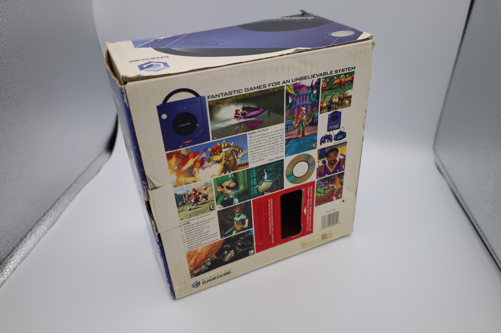 Nintendo GameCube Indigo console with original box, power adapter, and AV cable