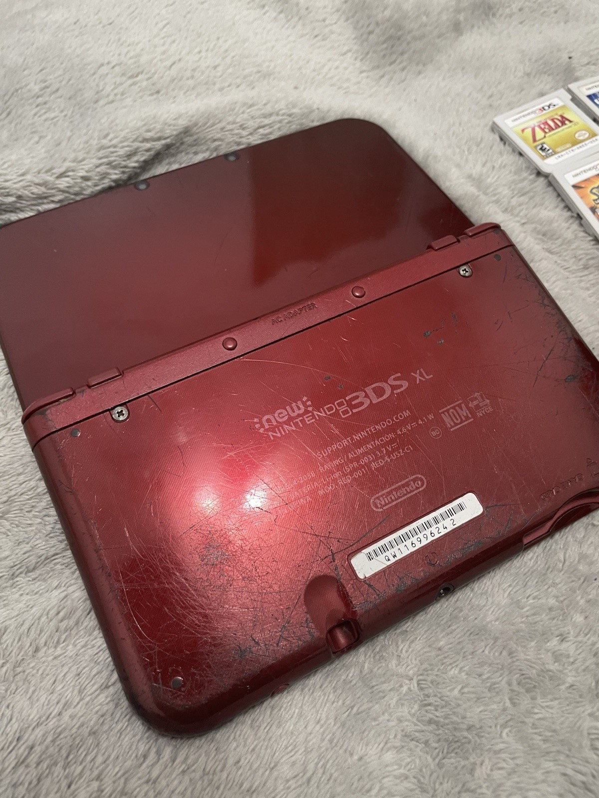 Nintendo 3DS XL (Red) with pouch and lots of games