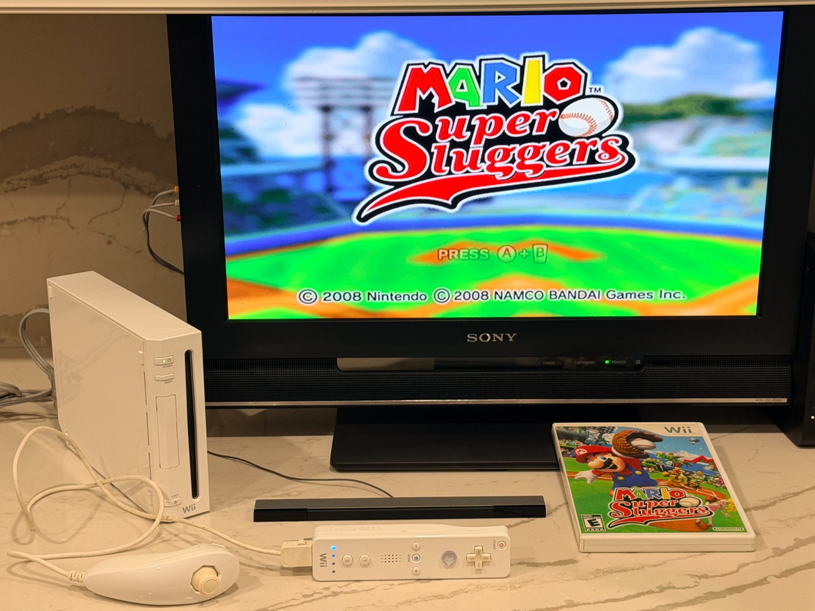 Nintendo Wii Console with Wii Remote, Nunchuck, Wires, Super Mario Sluggers Game